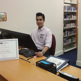 Daniel Molina, Communication &amp; Information (Masters Student, Information), Working the FIU Law library circulation desk